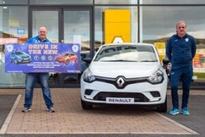 Ollie Horgan stands beside a Renault Clio for the Finn Harps Mega Car Draw