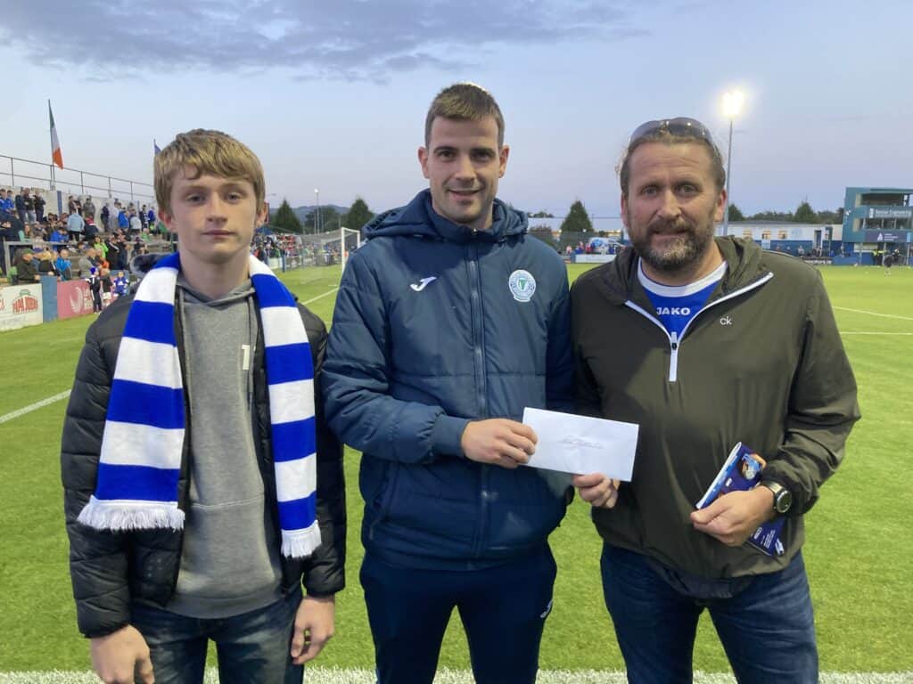 Adam & Eddie Gallen of match sponsors Northface Access present cheque to Harps player Conor Tourish at Finn Park on Friday.