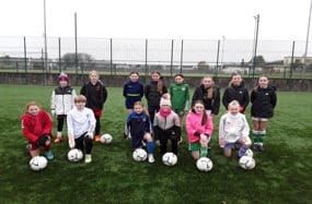 Young female footballers at a skills session