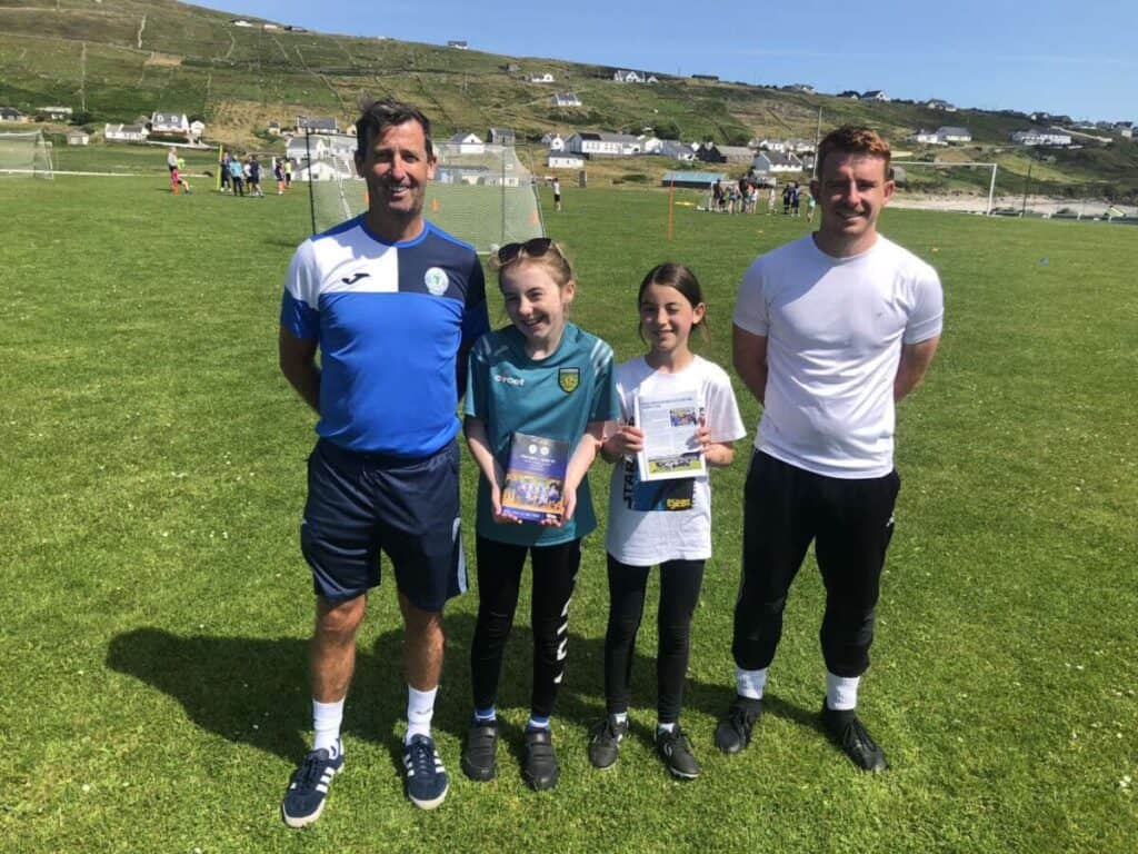 Pictured recently in Arranmore Island is Roisin Smyth along with her friend Aibhin Gallagher. Roisin wrote about their recent trip to Finn Park in our programme.  Head of Women's Development Paddy McDaid presented Roisin with some programmes and also included in rhe photo is Arranmore FC Football Camp organiser Brian Proctor.